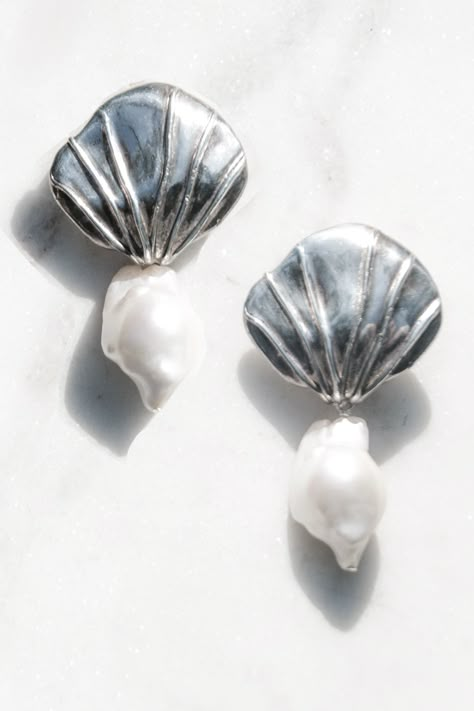 Large silver shell earrings earrings, part of our sustainable jewelry collection. These reworked earrings are comprised of baroque pearls and modernist inspired silver metal shell posts from the 1980s. Clip on backing.

Please note since this item is one of a kind, we only have one in stock. These were designed and conceived with the idea of these vintage earrings being worn as a "something borrowed" concept for a beach wedding. 

Earrings Size / 3 inches x 1.5 inches Silver Shell Earrings, Aesthetic Beach Wedding, Beach Wedding Earrings, Shell Accessories, Czech Jewelry, Jewelry Ocean, Ocean Aesthetic, Something Borrowed, Aesthetic Beach