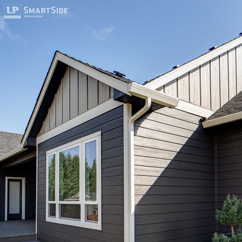 LP SmartSide panel siding comes in a variety of options for design flexibility, and it can be used to side all or part of a home. On this home, it's used in combination with LP SmartSide lap siding, trim and fascia. Gray Aluminum Siding House, Light Gray Vinyl Siding, Smart Siding Exterior, Light Gray Vinyl Siding House, Lp Smart Side Exterior Colors, Tundra Gray Lp Siding, Lp Smart Siding Exterior, Sterling Grey Vinyl Siding, Lp Smart Siding Tundra Gray