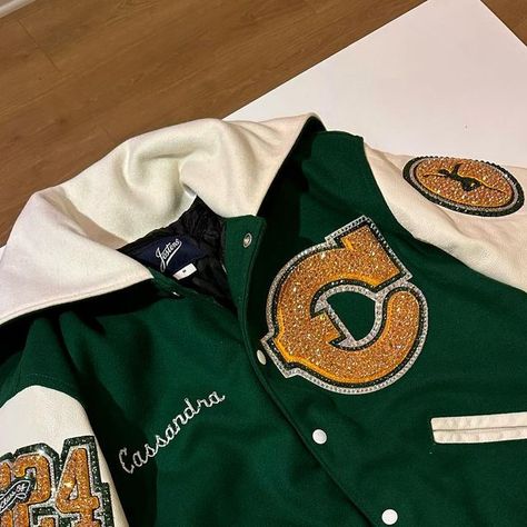 Mrs. Erica 💖 on Instagram: "Varsity dance team letterman jacket for Canyon High School! 💛💚✨✨✨💎 #LettermanJacket #BlingedLettermanJacket #VarsityCheerleader#Cheerleading #VarsityJacket #Cheer #Cheerleader #Varsity #HighSchoolCheer #Dance #DanceTeam #VarsityDanceTeam #VarsityDancer" Varsity Cheer Jacket, Cheer Varsity Jackets, Cheer Letterman Jacket Ideas, Cheer Letterman Jacket, Letterman Jacket Senior Pictures, High School Letterman Jacket, Letterman Jacket Ideas, Letterman Jacket Outfit, Black Letterman Jacket