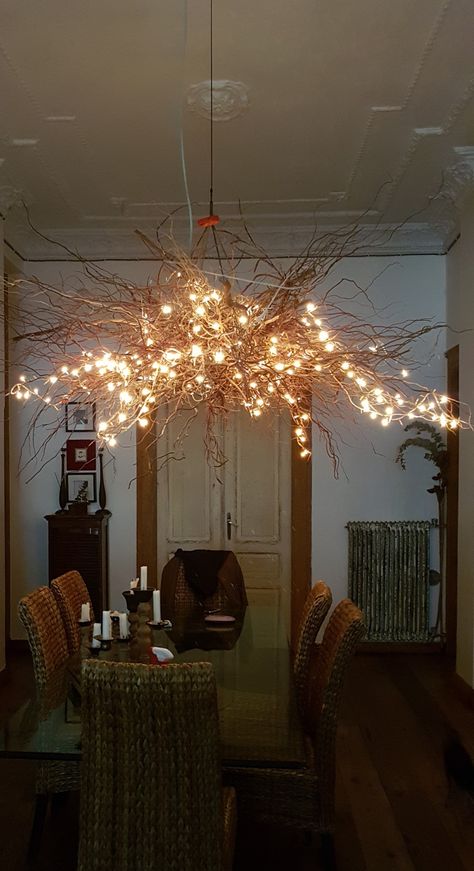 Tree branch chandelier with fairy lights Tree Branch Lighting Diy, Stick Chandelier Tree Branches, Diy Tree Chandelier, Branch Fairy Lights, Tree Branch Hanging Decor, Indoor Branches With Lights, Tree Branch Lighting, Tree Branch Chandelier Diy, Dry Flower Chandelier