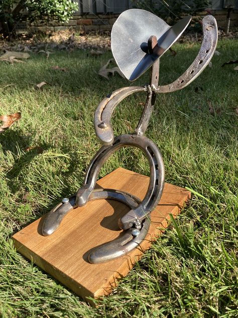 Horseshoe cowboy that resembles a bull rider! Each horseshoe is used and they come from various horses across West Alabama! Made with upcycled materials which would have otherwise been discarded

#horseshoecowboy #horseshoe #horses #horsedecor #horseshoedecor #horselover #cowboyart #cowboyhome #upcycled #homedecor #rusticdecor #tabletopart #bullriderart #bullriderdisplay #bullrider #broncrider #rodeoart Horseshoe Welding Projects, Horseshoe Cowboy, Bull Rider, Horseshoe Decor, Home Decor Table, Horseshoe Art, Bull Riders, A Bull, Cowboy Art