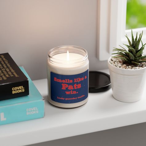 Are you a devoted member of Pats Nation? Elevate your fan status with our exclusive "Smells like a Pats win" candle, meticulously designed for the upcoming season, whether it's football or basketball. Elevate your game day experience with our specialty candle, thoughtfully formulated to immerse you in one of five delightful scents. Choose from White Sage + Lavender, Clean Cotton, Sea Salt + Orchid, Apple Harvest, or Cinnamon Vanilla, and let the winning aroma invigorate your surroundings. This candle isn't just for personal use; it's a meaningful gesture for family, friends and all your favorite fans. Whether it's a holiday surprise or an enhancement for game day celebrations with the ultimate fan in your life, this candle encapsulates the essence of devotion. Crafted from a blend of 100% Specialty Candles, Joe Louis, College Football Season, Georgia Football, United Center, Basketball Season, Bowl Game, Football Gift, Raider Nation