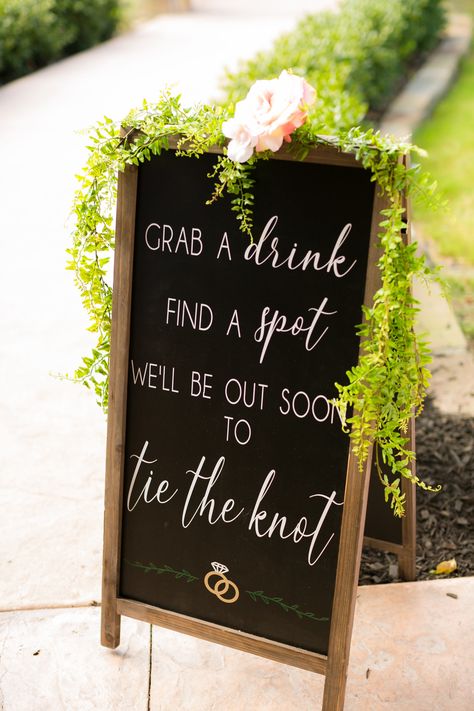 | modern wedding ceremony sign | modern rustic wedding decorations | wedding signs with greenery | "grab a drink, find a spot, we'll be out soon to tie the knot" | unique wedding ceremony signs | outdoor wedding ceremony | photo taken at THE SPRINGS Event Venue. follow this pin to our website for more information, or to book your free tour! SPRINGS location: Westwood Hall in Weatherford, TX photographer: Swan Photography #weddingsign #rusticwedding #outdoorwedding #rusticweddingdecor #weddings Wedding Ceremony Sign, Modern Rustic Wedding, Modern Wedding Ceremony, How To Dress For A Wedding, Rustic Wedding Decorations, Ceremony Sign, Wedding Ceremony Signs, Rustic Modern Wedding, Wedding Ceremony Photos