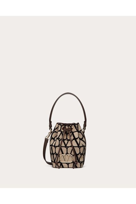 Find VALENTINO Mini Vlogo Signature Bucket Bag In Toile Iconographe on Editorialist. Valentino Garavani VLogo Signature mini bucket bag in Toile Iconographe. Equipped with a removable shoulder strap and handle, this mini bag can be worn as a crossbody/shoulder accessory or carried as a handbag. - Platinum-finish logo and hardware - Drawstring closure - Removable handle - Removable shoulder strap - Nappa leather lining - Shoulder strap drop length: 55 cm / 21.6 in. - Handle drop length: 12 cm / 4.7 in. - Dimensions: W12xH18xD10 cm / W4.7xH7.0xD3.9 in. - Made in Italy Mini Bucket Bag, Mini Bucket Bags, Mini Bucket, Fendi Belt, Saint Laurent Wallet, Prada Wallet, Fendi Wallet, Dior Wallet, Lv Belt