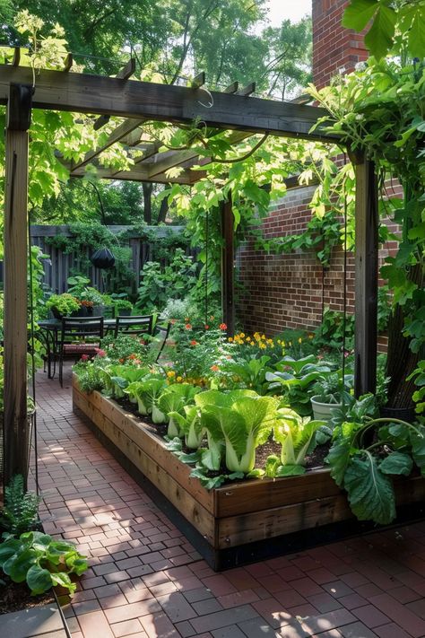 A lush garden featuring raised beds with leafy greens and flowers under a wooden pergola, with a patio dining area in the background. Backyard Vegetable Garden Ideas, Backyard Vegetable Garden, Vegetable Garden Ideas, Small Vegetable Gardens, Garden Planter Boxes, Chicken Garden, Backyard Vegetable Gardens, Aesthetic Garden, Farmhouse Garden