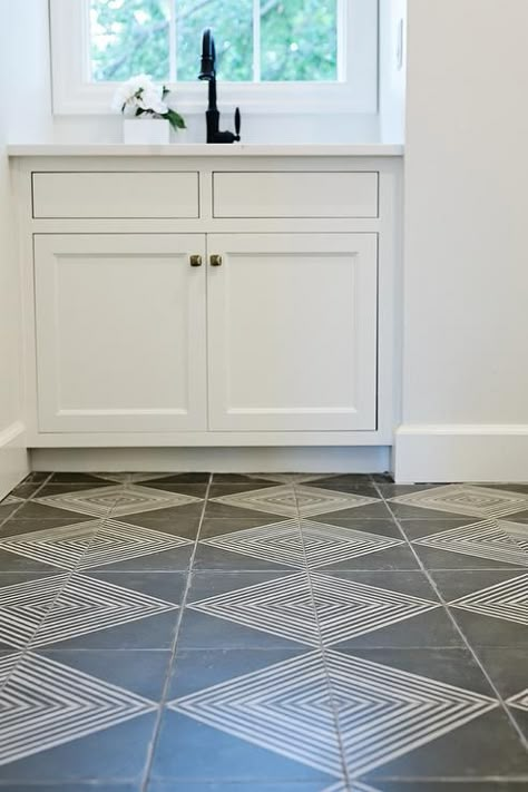 Beautiful gray and white laundry room features white and gray diamond pattern floor tiles leading to white cabinets fitted with brass knobs and a white countertop finished with a sink and an oil rubbed bronze gooseneck faucet positioned in front of a window. Laundry Room Tile, White Laundry Rooms, White Laundry, Patterned Floor Tiles, Room Tiles, White Countertops, Laundry Mud Room, Tile Flooring, Bathroom Floor Tiles