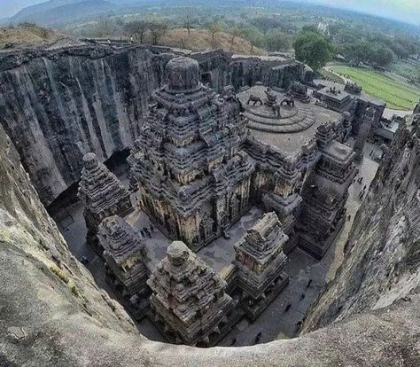 Ellora in the Aurangabad district of Maharashtra is one of the largest rock-cut Hindu temple cave complexes in the world. A UNESCO World Heritage Site, it is home to over 100 caves of which 34 are open to the public.All the caves have been excavated from the basalt cliffs in the Charanandri Hills. Known as the Ellora Caves collectively, caves number 1 to 12 are Buddhist caves, 13 to 29 are Hindu caves and Jain caves are number 30 to 34. The Hindu and Buddhist caves at Ellora were built during th Mountain Sculpture, Ellora Caves, Ancient Indian Architecture, Temple Design For Home, Ganpati Decoration Design, Mysterious Places, Indian Architecture, Hindu Temple, Ancient Temples