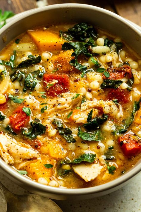 This “New American Heartland” fall chicken stew recipe is bulked up with quinoa and butternut squash. The dish is hearty and filling, and a perfect fall or winter dinner recipe. #souprecipe #stewrecipe #fallrecipe Butternut Squash Chicken Tortellini, Chicken Vegetable Quinoa Soup, Chicken Kale Butternut Squash Soup, Soup Recipes Half Baked Harvest, Chicken Stew With Butternut Squash, Fall Chicken Recipes Healthy, Chicken Sausage Butternut Squash Recipes, Chicken Soup With Butternut Squash, Autumn Chicken Soup