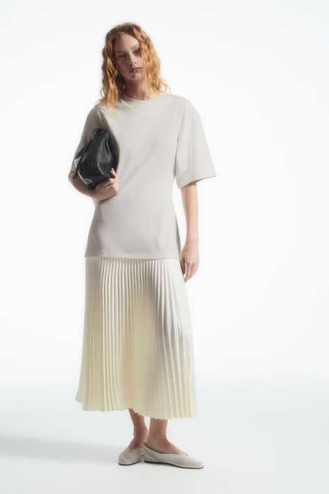 The COS womenswear team have updated the classic T-shirt dress for the upcoming season. Crafted from pure cotton, it's shaped with a round neckline, dropped shoulders and half sleeves. The dropped waistband creates a fluid shape, while the sunray-pleated satin skirt lends movement. Regular fitMidi length Shell: 100% Cotton. Excluding trims / Machine wash Back length of size S is 51.34" / Model wears a size S Satin Skirt, Linda Farrow, Innovative Design, Half Sleeves, T Shirt Dress, Wardrobe Essentials, Pleated Skirt, Round Neckline, Pure Cotton