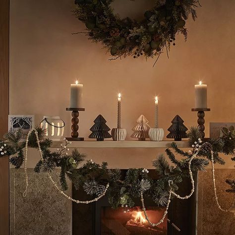 Mantlepiece decorated with candles, garlands and light-up candles. Shop Christmas wreaths Fireplace Decoration Ideas, Mantlepiece Decor, Enchanted Forest Decorations, Cosy Fireplace, Candles Shop, Christmas Fireplace Decor, Forest Decor, Tall Candle, Hanging Garland