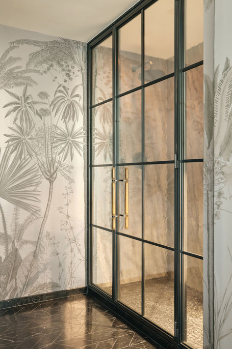 This custom stainless steel and glass shower door with bronze hardware made fully by Amuneal features a 1 way reflective mirror which allows the shower door to function as a mirror and the room to feel like a powder room for entertaining while allowing the room to transition to a guest suite with full bath in a future update.  Once the light is on you can see through the glass into the shower. Mirrored Shower Door, Quartz Island, One Way Mirror, Glass Wall Design, Wall Panel System, Rolling Ladder, Glass Shower Door, Kitchen Installation, Panel Systems