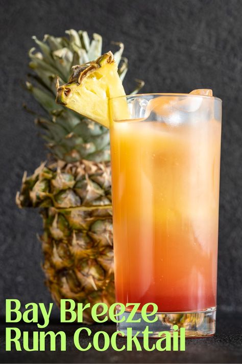 This Bay Breeze is a pretty tropical cocktail that has only 3 ingredients. Coconut rum and fruit juices come together for this refreshing Malibu recipe perfect for sipping pool side, enjoying as a game day mixed rum drink or anytime! Blue Chair Bay Banana Rum Recipes, Rum Punch Recipes For A Crowd, Tropical Drinks Recipes Alcohol, Rum Drinks Easy Cocktails, Banana Rum Recipes, Beach Drinks Alcohol, Rum Bucket Recipe, Drinks With Rum, Bay Breeze Drink