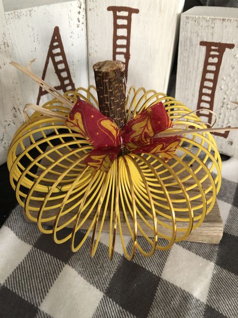 Slinky from Dollar Tree pulled together with floral wire. I glued stick from my yard to scrap wood and now we have a easy diy pumpkin Diy Slinky, Fall Rec, Crochet Popsicle, Making Pumpkins, Vase Makeover, Mailbox Planter, Pearl Wreath, Crafts Dollar Tree, Fall Diys