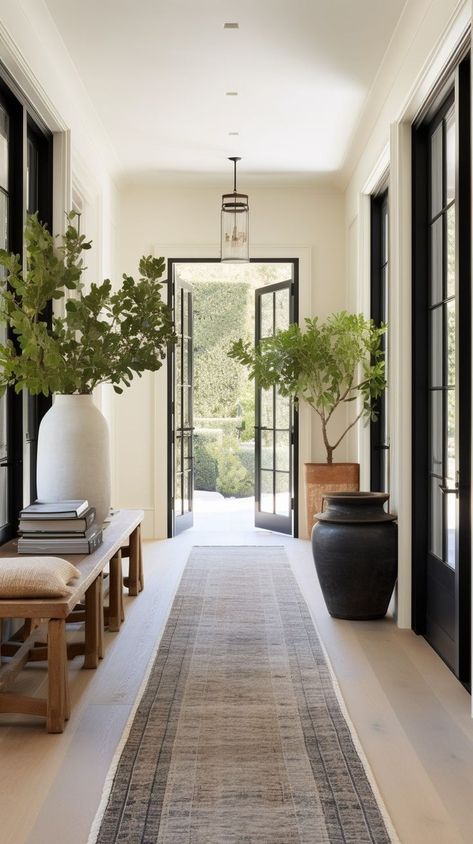 A beautifully well proportioned hallway with lovely black French doors, a gorgeous rug and fabulous styling Modern Building Entrance Design, Window To Floor, Timeless Home Interior Design, Modern European House Interior Design, European Style Home Decor, Internal House Design, Floor To Ceiling Art, Modern Timeless Interior Design, Ceiling Design Farmhouse