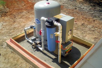 Well Houses, Remotes, and Buried Systems | Miller Well Drilling Well Pump House Ideas Buildings, Water Well Design, Well Pump House, Grey Water System Diy, Water Well House, Well Pressure Tank, Well Water System, Submersible Well Pump, Barrels Diy