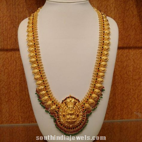 22k gold antique mango haram with lakshmi pendant. The haram is embellished with rubies and emeralds. Lakshmi Jewellery, Lakshmi Pendant, Mango Haram, Jewelry White Gold, Temple Jewelry Necklace, Gold Temple Jewellery, Gold Jewels Design, Bride Jewelry Set, 22k Gold Jewelry