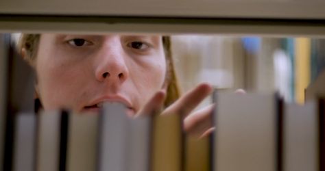 Young man taking a book off a bookshelf in a library - close up shot through shelf Stock Video Footage 00:10 SBV-334166996 - Storyblocks Movie Close Up Shots, Library Cinematography, September Reads, Library Photo Shoot, Library Shelf, Colour Grading, Library Bookshelves, Library Shelves, Movie Shots