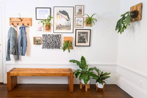 This minimalist space still has plenty of personality. The entryway has a stunning gallery wall with tons of smart gallery wall ideas and inspiration. We love the plants hanging from the wall and the natural wood elements throughout. Palladian Window, Gallery Wall Ideas, Plants Hanging, Minimalist Space, Decoration Plante, Minimal Home, Wall Hanging Diy, Decor Accents, Wall Ideas