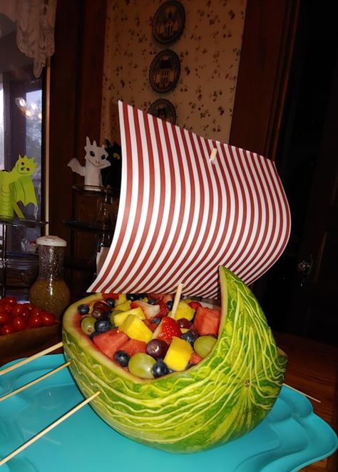 Carved a viking ship out of a watermelon. Used paper for the sail and skewers for ores. Viking Themed Party Food, Viking Party Food Ideas, Viking Party Food, Viking Gender Reveal, Vikings Theme Party, Viking Decorations Party, Viking Party Decorations, Viking Party Ideas Adults, Viking Baby Shower Ideas