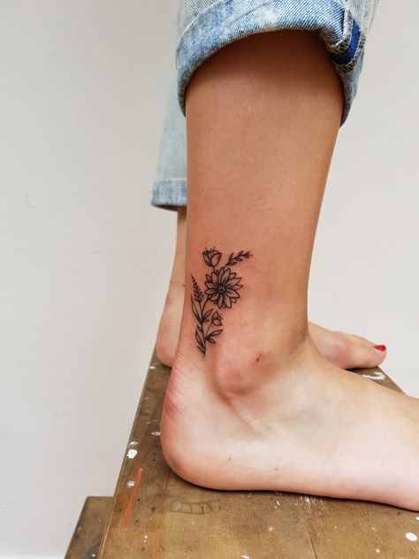 Women's Flower Tattoos, Small Tattoos For Women Back Of Arm, Always More Tattoo, Inner Ankle Flower Tattoo, Simple Leg Tattoos Women Lower Calf, Birth Flower Tattoo Placement For Women, Thumbprint Flower Tattoo, Placement For Tattoos For Women, Ankle Flower Tattoos For Women