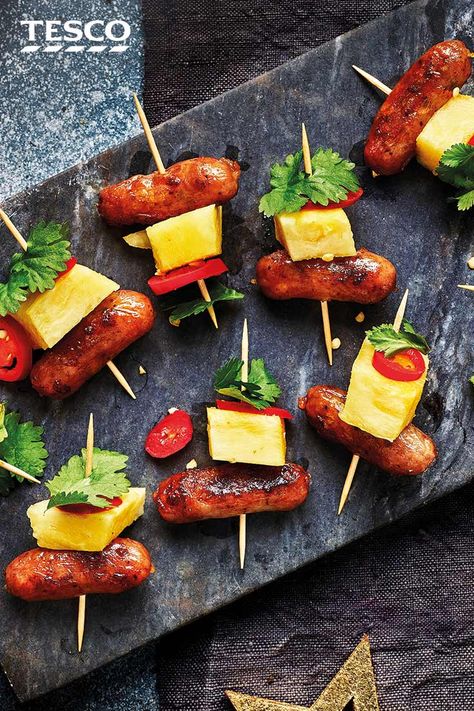 Layer up sticky honey glazed cocktail sausages with juicy pineapple, spicy chilli and coriander for these colourful Hawaiian skewers - a party-pleasing canapé. | Tesco Hawaiian Skewers, Cocktail Sausage Recipes, Beach Party Food, Sausage Appetizers, Spicy Chilli, Big Family Meals, Cocktail Sausages, Hawaiian Dishes, Yummy Healthy Breakfast