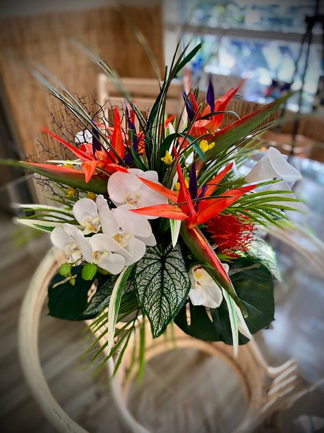 Bright and beautiful tropical arrangement for Medium Table of 4-6 seatings.  Bird of paradise, protea, cymbidium, calla lily, dancing orchid,  calla lily and etc... Fantastic dinner centerpiece for tropical scheme. Size: 22"diameter.15-16" height include glass base      Free Shipping for continues USA. May need help from HAWAII and VIRGIN ISLAND folks may be some extra shipping. ∞ This  floral arrangement has real look.  It look so real till you touch!      Arranged by certified floral designer Banana Leaf Centerpiece, Tropical Floral Design, Zantedeschia Aethiopica, Dinner Centerpieces, Tropical Centerpieces, Tropical Floral Arrangements, Tropical Wedding Flowers, Wedding Arrangements, Tropical Floral