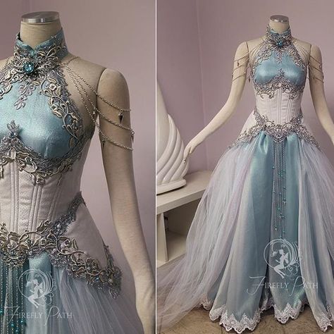 Our customer sent us an image of Tyrande Whisperwind from World of Warcraft to use as inspiration in her gown design. I wanted to give the feeling that her gown was woven from moonlight! We used a two-tone crinkle barbie organza over a teal satin to give that moonlight glow. Her corset and peplums are made from a iridescent tiny scale patterned brocade. We stacked silver vine lace over a floral metallic lace to trim her neckline and corset. For that midnight glimmer, crystals and pearls twin... Firefly Path, Gaun Abad Pertengahan, Elf Dress, Silver Fairy, Fest Outfits, 파티 드레스, White Corset, Fantasy Dresses, Fantasy Gowns