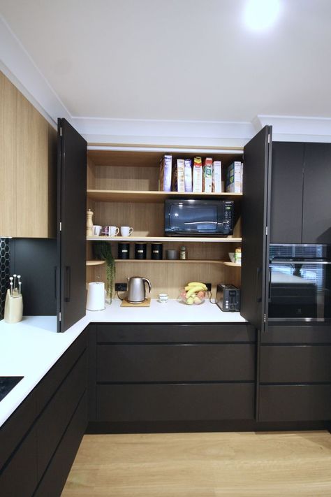 Custom appliance cabinet, with large bi-fold doors in a matte black lamiwood. Constructed with lamiwood timber grain internals, with a stone benchtop. #kbecastlehill #kitchensbyemanuel #kitchenideas #appliancecabinet #ideas #custom #local #storage #practical Kitchen Cabinet Folding Door, Bifold Kitchen Cabinet, Appliance Cupboard Kitchen, Bifold Cabinet Doors, Appliance Cupboard, Beige Living Room Decor, Cabinet Door Ideas, Stone Benchtop, Modern Kitchen Appliances