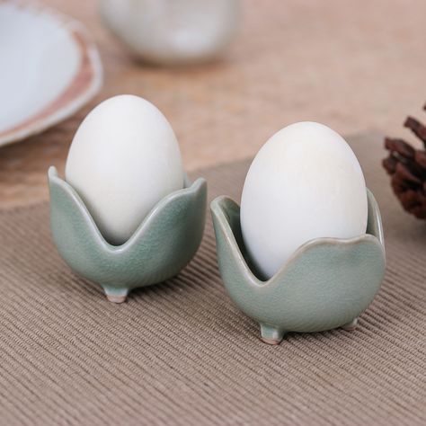 These lovely green tulips will be ready to hold those nutritious eggs at any moment of the day. Crafted in Thailand by Nopnara, this pair of celadon ceramic egg cups come in a tender floral shape for an adorable vibe, and their sturdy structure, enhanced by a crackled finish, makes them perfect for kitchen use. Clay Bowl Egg, Functional Pottery Jewelry, Ceramic Egg Storage, Egg Clay Bowl, Egg Cups Pottery, Egg Cups Ceramic Pottery, Eggshapes Ceramics Art, Pottery Egg Cups Handmade, Interesting Ceramic Ideas