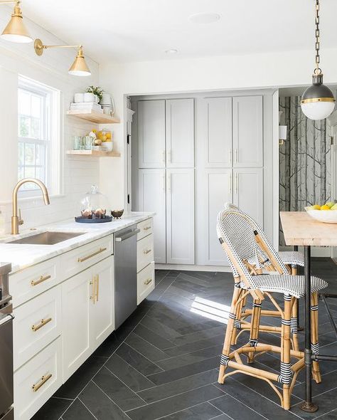 White and gold kitchen features white shaker cabinets adorned with brass hardware paired with calcutta marble countertops and a white subway tile backsplash facing a wall of floor to ceiling gray cabinets painted Benjamin Moore cape May Cobblestone. Kitchen Floor Inspiration, Dark Kitchen Floors, Herringbone Kitchen, Herringbone Tile Floors, White Shaker Cabinets, Slate Flooring, Herringbone Floor, Casa Vintage, Herringbone Tile