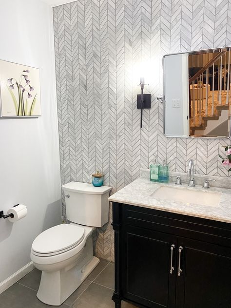 Another design project in the books! This powder room was transformed into a gorgeous modern oasis with a chevron tile backsplash/ accent wall, simple black vanity, marble counter top, and mixed metals of chrome and matte black finishes 🙌🏼.  #liketkit #LTKhome #LTKfamily @liketoknow.it @liketoknow.it.home http://liketk.it/2KQak Tiled Walls In Powder Room, Power Room Tile Wall, Powder Room Ideas With Tile Wall, Powder Bathroom Tile Wall, Tile Wall In Powder Room, Tiled Wall Powder Room, Half Bathroom Ideas Wallpaper Modern, Powder Room Tile Accent Wall, Powder Room Half Wall Tile