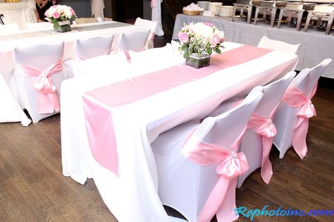 Guests seating. White table linens, pink runners and satin pink sashes White Table With Pink Runner, Pink And White Table Decor, White Table Cloth With Pink Runner, Wedding Pink Tablecloth, Light Pink Table Runner, Pink Round Table Clothes, Pink Plastic Table Cloth, Pink Satin Tablecloth, Gold Quinceanera