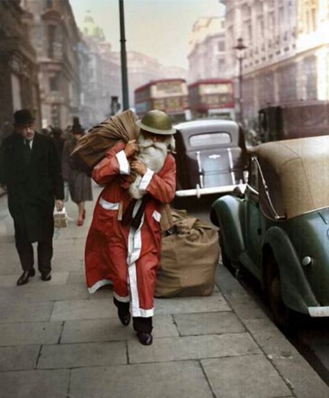 A Father Christmas wearing a tin helmet, walks along Regent Street, London.  23rd December 1940 Military Christmas, London In December, Vintage Christmas Photos, Colorized Photos, London Christmas, Old London, Christmas Past, British History, Second World