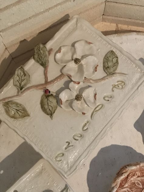 Believe plaque with dogwood bloom Pretty Ceramics, Tile Art Projects, Clay Relief, Ceramic Plaque, Handbuilt Pottery, Dogwood Blooms, Pottery Inspo, Garden Plaques, Diy Ceramic