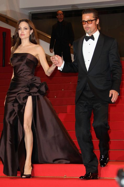 Angelina Jolie and Brad Pitt leave The Tree of Life premiere during the 64th Annual Cannes Film Festival on May 16, 2011, in Cannes, France. Getty -Cosmopolitan.com Angelina Jolie Black Dress, Angelina Jolie Make Up, Angelina Jolie Red Carpet, Versace Atelier, Angelina Jolie Style, Brad And Angelina, Brad Pitt And Angelina Jolie, Angelina Jolie Photos, Jolie Pitt