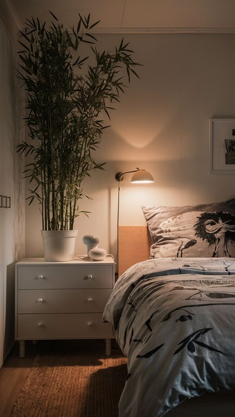 Elevate your bedroom's ambiance with a touch of nature! This serene setup features a beautiful bamboo plant on a sleek MALM dresser, perfectly complemented by the minimalist KNARREVIK nightstand and the warm glow of a SINNERLIG lamp. The expressive BERGPALM duvet cover adds a pop of personality, while the VIDJA floor lamp casts a cozy, diffused light throughout the space. Discover how to create your own tranquil retreat and bring the outside in! Click for styling tips and inspiration! #BedroomDecor #IKEAStyle #BambooPlant #CozyHome #InteriorDesign #NatureInspired #HomeStyling Knarrevik Nightstand, Bergpalm Duvet, Ikea Style, Malm Dresser, Bamboo Plant, Bedroom Ambiance, Bedroom Oasis, Tranquil Retreat, Serene Bedroom