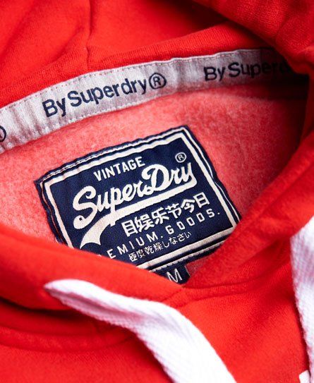 Superdry men's Vintage Logo Tri hoodie. The classic hoodie from Superdry featuring a puff-print version of the iconic Real Superdry logo design. This hoodie also features a drawstring hood, front pouch pocket and is finished with a Superdry logo tab on the sleeve. Streetwear Startup, Drop Kick, Superdry Logo, Line Branding, Superdry Mens, Puff Print, Red Hoodie, Vintage Logo, Pocket Pouch