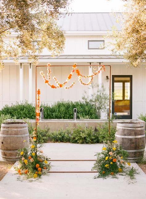 A pop of Marigold wedding inspiration – Inspired By This Hangung Flower Backdrop, Marigold Wedding Arch, Colorful Wedding Ceremony Decor, Lei Backdrop, Marigold Arch, Marigold Wedding Colors, Marigold Wedding Decor, Marigold Mandap, Marigold Wedding Flowers