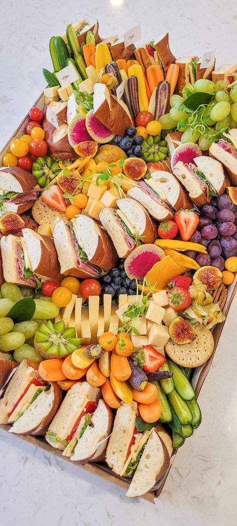 This platter is perfect for any meeting, party or family event.  Never thought a sandwich platter could stand out? Let us dazzle your guests!   Each includes: Smoked meat sandwiches, mini sandwiches, cheeses, an assortment of crackers, seasonal fruits, mini cakes, cupcakes, cookies, olives, and other party favourites. Sandwich Platter Ideas, Sandwich Platters For Parties, Fresh Fruit Display, Platters Grazing, Housewarming Food, Sandwich Party, Meat Sandwiches, Charcuterie Party, Sandwich Platter