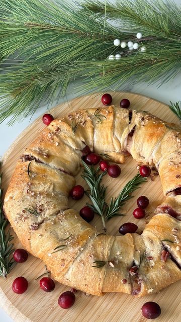 Audrey Lillian on Instagram: "Cranberry Brie Pull Apart Wreath   I’ve seen this recipe so many times and finally gave it a try! I can say it’s 100% worth the hype and such an easy yet beautiful appetizer to make for the holidays. Give it a try, you’ll love it!   Ingredients: -2 rolls @pillsbury crescent dough  -1/2 cup cranberry sauce  -1/2 wheel of Brie  -1/4 cup pecans   Optional toppings: -butter  -coarse sugar  -pecans  -rosemary sprigs  -fresh cranberries  -honey   Instructions: 1. Preheat oven to 375F. Unroll and cut apart crescent dough. Place a small plate or bowl in the center of some parchment paper or a lined baking sheet and layer the dough around it to create a wreath shape.  2. Spread your cranberry sauce onto the dough. Top with Brie slices, add more cranberry sauce and spri Brie Wreath Appetizer Puff Pastry, Cranberry And Brie Crescent Ring, Baked Brie Pillsbury Crescent Rolls, Pull Apart Wreath, Cranberry Brie Pull Apart Bread, Cranberry Brie Puff Pastry, Bunco Christmas, Philo Dough, Puff Pastry Twists