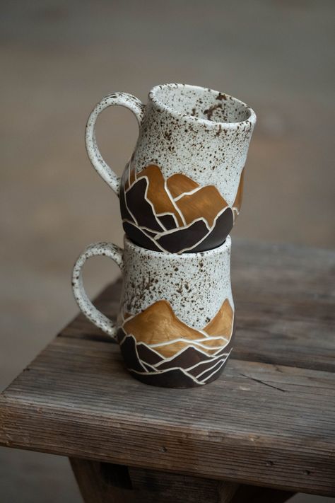 Handmade mugs decorated with sgraffito designs - OOAK and filled with love! These cups are of a B mix white clay body, decorated and made functional with a beautiful earthy speckled crème glaze. At the bottom, you'll feel the earthiness of raw-kept underglaze.  This is a listing for the SET of 2 mugs with handles as shown in the images - though, these will be made to order and thus will slightly, barely noticeably, differ. These cups are not dishwasher- or microwave safe. Sculptural Mug, Pottery Espresso Cups, Mug Ceramic Ideas, Pottery Gifts For Men, Ceramic Mugs Handmade, Carving Pottery, Sgraffito Designs, Creative Mugs, Mug Ideas