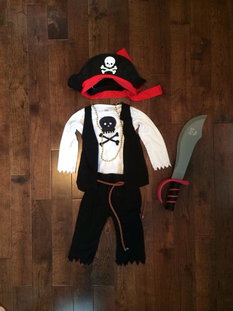 Baby/Toddler DIY Pirate costume  Hat & sword $2 each from target, belt from the fabric store, gold necklace from the dollar store, clothing from the second hand store & permanent marker used to draw the skull onto his shirt. Toddler Pirate Costume Diy, Pirate Hat Crafts, Toddler Pirate Costumes, Diy Pirate Costume, Diy Pirate Costume For Kids, Boys Pirate Costume, Pirate Costume Kids, Diy Pirate, Pirate Costume Diy