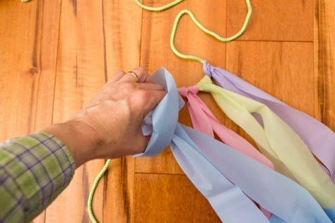 Add tablecloth streamers to your string to create a streamer-laden photo backdrop. Table Cloth Streamers Plastic Tablecloth, Tablecloth Streamers, Plastic Tablecloth Decorations, Plastic Tablecloth Backdrop, Make A Tablecloth, Easter Photo Backdrop, Tablecloth Backdrop, Streamer Wall, Diy Streamers