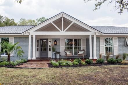 Fresh landscaping with ornamental grasses and a dwarf palm also contribute to an underlying coastal theme. Farmhouse Style Exterior, Ranch House Remodel, Ranch House Exterior, Porch Remodel, Ranch Remodel, Porch Addition, Brick Ranch, Farmhouse Landscaping, Farmhouse Remodel