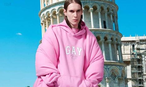 The collection includes a pink oversized hoodie with the inscribed word “GAY” styled as the GAP logo. Balenciaga will be donating 15% of the sales from Pride capsule to The Trevor Project. Pride Hoodie, Gap Hoodie, Gap Logo, Clothing Logo, Pride Month, Capsule Collection, Pink Hoodie, Pre Fall, Gay Pride