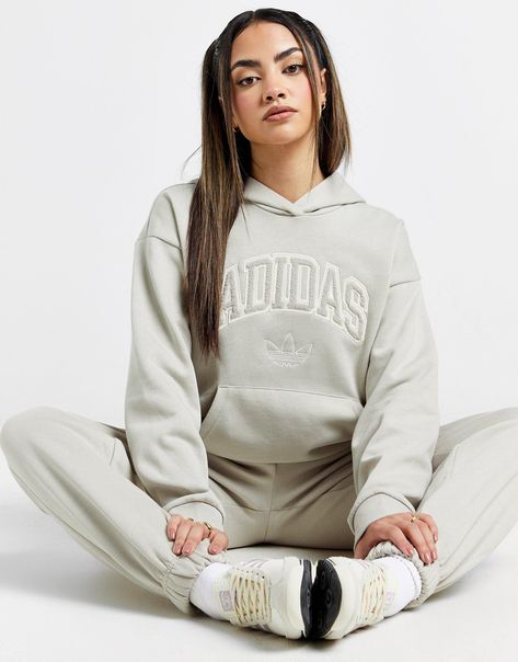 Exclusive to JD. Make room in your rotation for this women's Cosy logo Hoodie from adidas Originals. In a Putty Grey colourway, this oversized pullover is made from a fleecy cotton and recycled polyester fabric that's smooth on the outside and fuzzy on the inside. It features dropped shoulders, ribbed trims and a spacious kangaroo pocket. Finished off with tonal adidas Originals branding, including the signature Trefoil on the chest. Machine washable. | Our model wears a size small. | JI9822