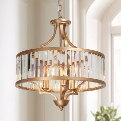 This 3-light drum chandelier is a focal point with its glam gold finish and simple drum design, evoking a high-end elegance without sacrificing the classic touch. Crafted from the gold metal, this chandelier features a drum work frame covered by transparent glass. Inside the frame sit three sophisticated candle-stick bases that support three lighting bulbs (E12/up to 40W/not included) to provide sufficient lighting. Suspended in you entryway, dining room, foyer or living room, this chandelier no Drum Chandelier Entryway, Gold Chandelier Entryway, Gold Bathroom Chandelier, Breakfast Nook Pendant Light, Nook Lighting, Bathroom Chandelier Lighting Gold, Gold Dining Room Light Fixture, Small Gold Chandelier Entryway, Foyer Pendant Light Entryway