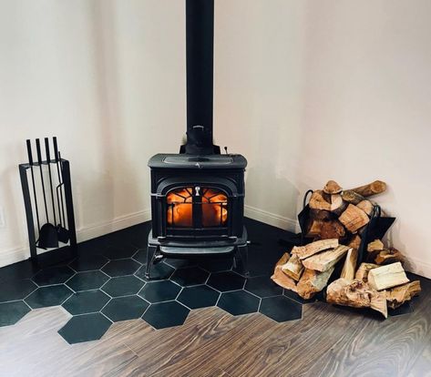 Tile Wall Behind Woodstove, Wood Stove Black Tile, Wood Burning Stove Backsplash Ideas, Tiled Wood Stove Surround, Tile Hearth Wood Stove, Tile Under Wood Stove, Woodstove Backing Ideas, Small Ski Chalet Interior, Corner Wood Stoves Ideas Living Rooms