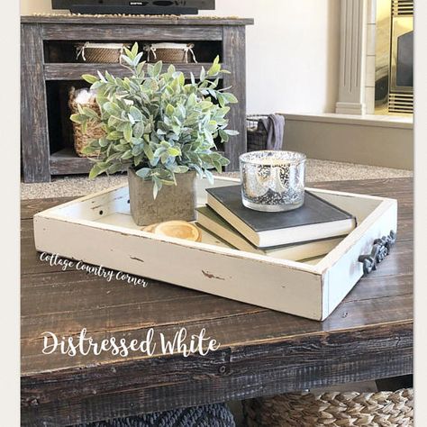 This adorable tray makes the perfect addition to your home! Use as a coffee table tray, magazine tray, breakfast tray, etc. This tray is so versatile! The decorative handles add an elegant farmhouse touch. Pictured color is Distressed White. Dimensions are 20 x 14 x 2.5. Diy Coffee Tables Ideas, Farmhouse Coffee Table Decor, Wooden Ottoman Tray, Coffee Table Decor Tray, Coffee Tables Ideas, Diy Coffee Tables, Farmhouse Coffee Table, Decor Tray, Tray Coffee Table