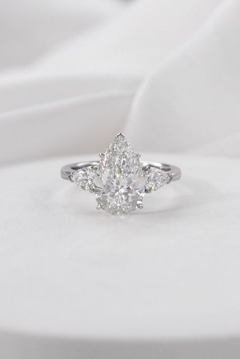 Diamond Rings Pear Shape, Pear Shape Diamond Engagement Rings, Pear Engagement Ring Silver Band, Pear Diamond With Side Stones, Pear Shaped Engagement Rings White Gold, Pear Trilogy Engagement Ring, Silver Pear Engagement Ring, Pear Three Stone Engagement Ring, Pear Engagement Ring Silver